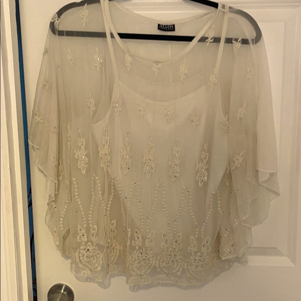 Flowy white blouse with floral details